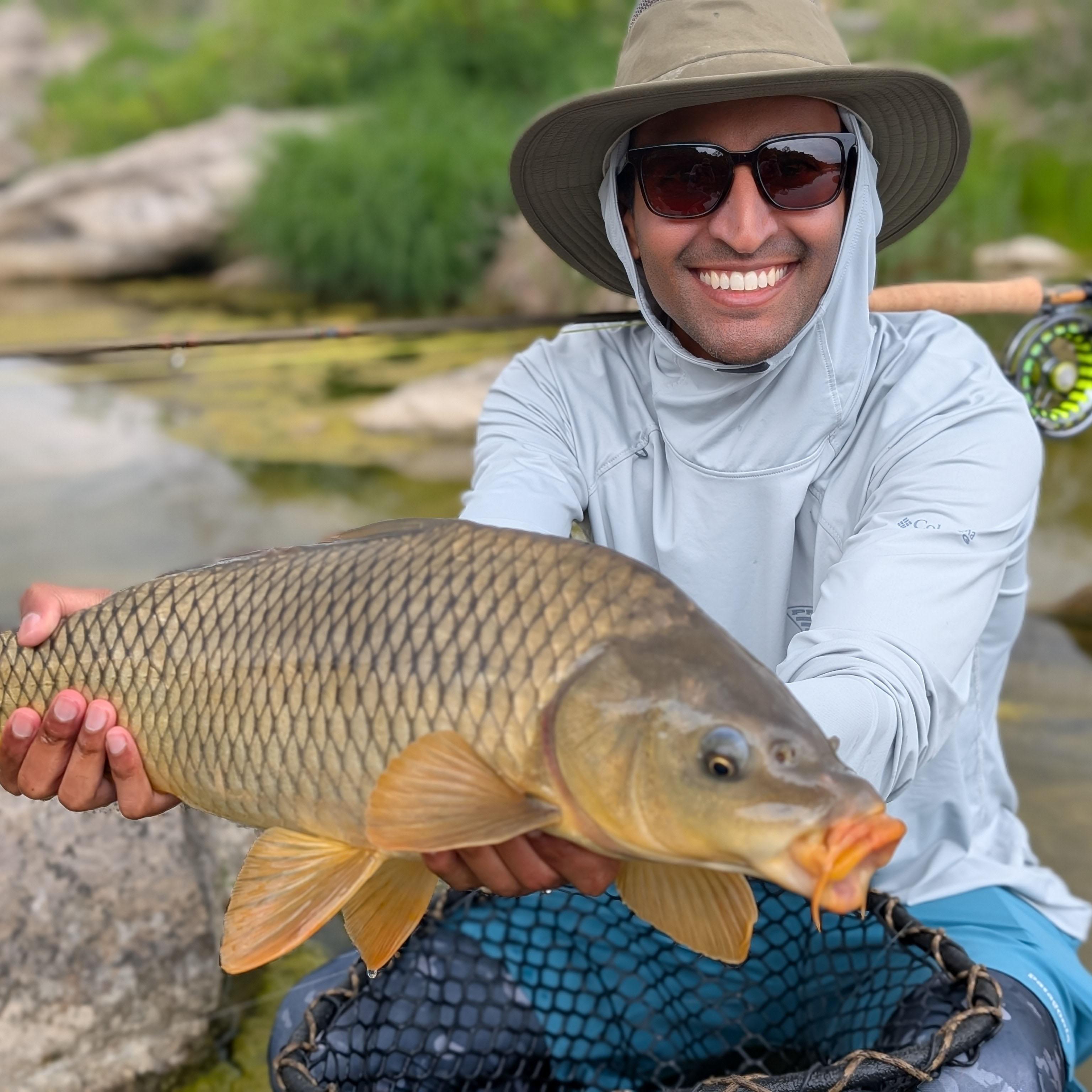 Rehman holding a large common carp.